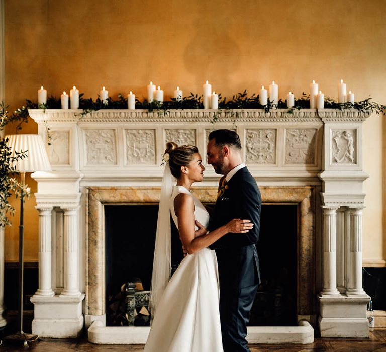 The bride and groom pose for couple portraits at Hampton Court House for their wedding day 