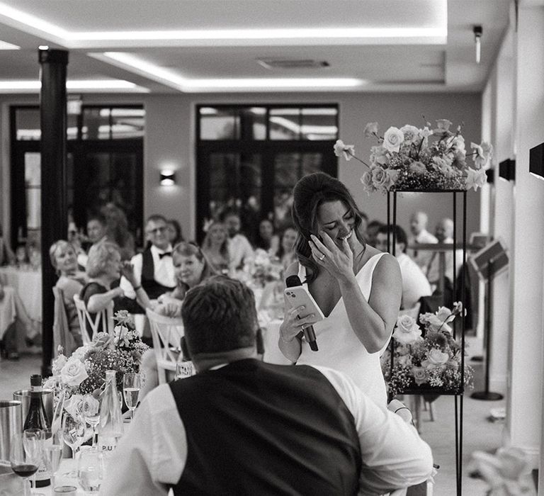 Bride wipes her tears as she reads out her bridal wedding speech 