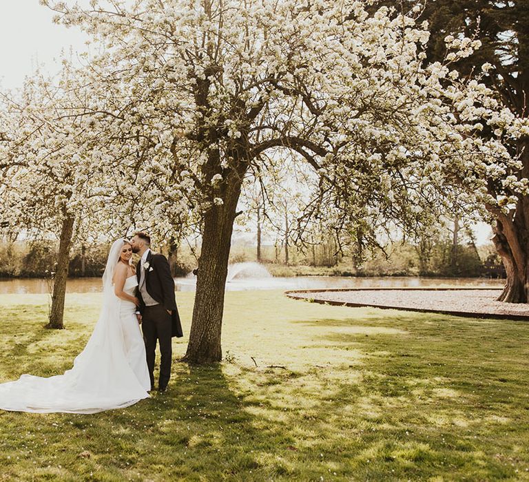 Classic and elegant wedding theme with the bride in a strapless wedding dress and groom in black and grey morning suit 