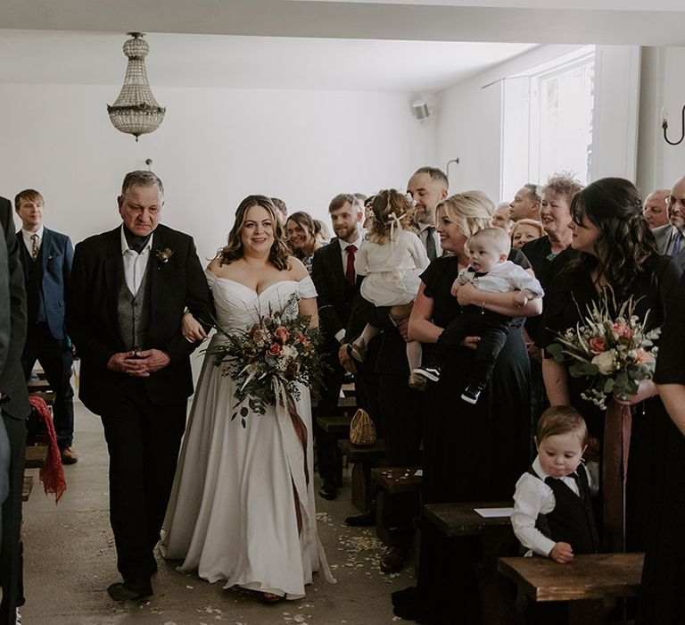 Father of the bride walks the bride in a Madi Lane wedding dress down the aisle at Aswarby Rectory wedding venue 