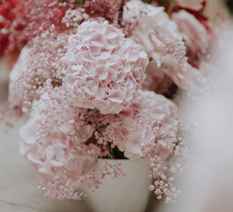 Baby pink wedding flower arrangements with hydrangeas and gypsophila 