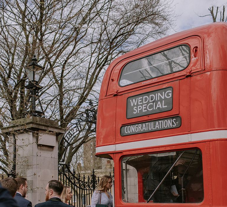 The Bedford wedding in London with guests arriving by an iconic red double decker bus transportation 