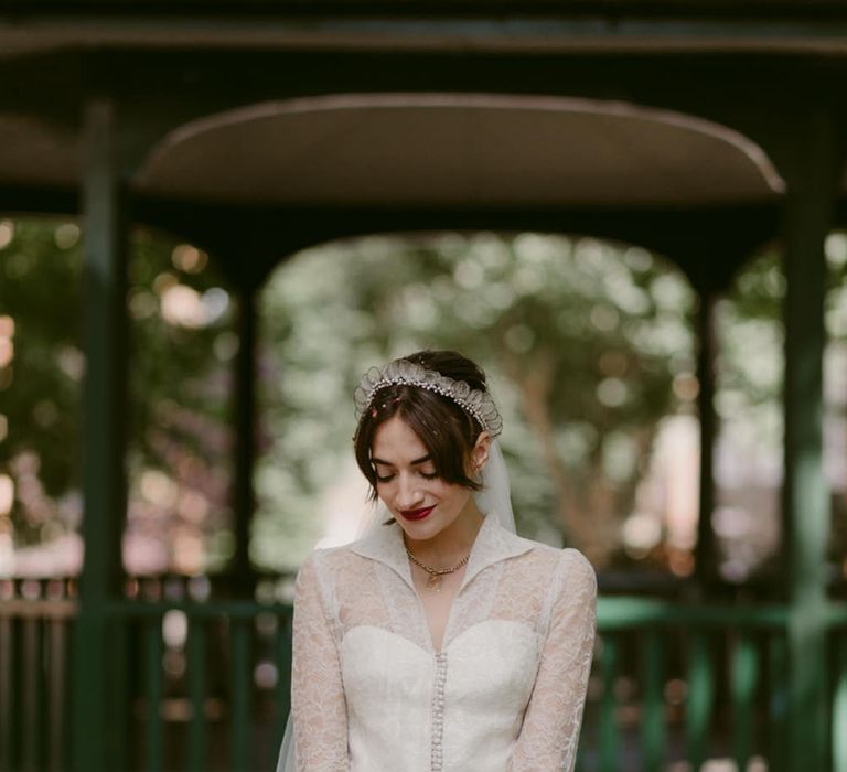 Long sleeve lace wedding dress holding bouquet for autumn wedding 