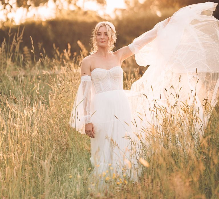 Golden hour portrait of bride in a strapless tulle wedding dress with detachable sleeves