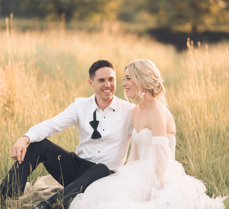 Romantic bride and groom photograph in a field