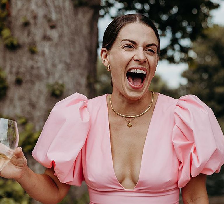 Wedding guest wearing pink puff sleeve dress by Richard Skins Photography