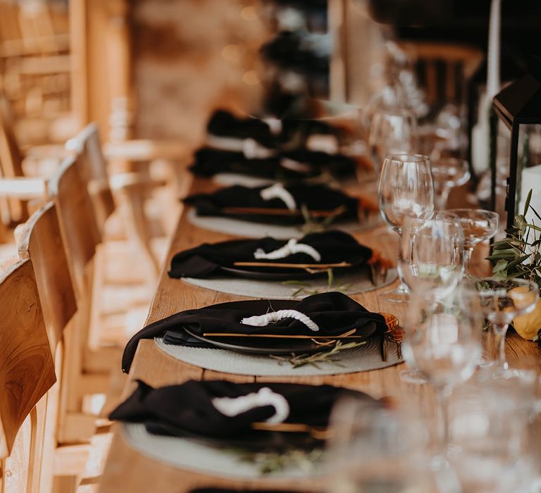 Black wedding place setting and table decorations at destination wedding 