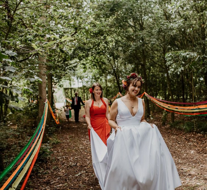 Bride walking down the streamer decorated aisle 