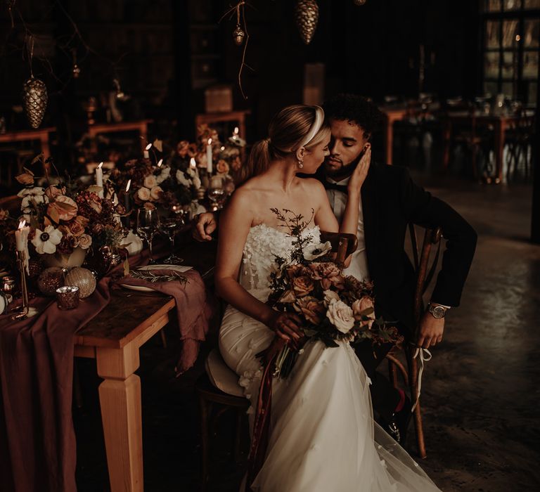 Bride and groom sitting at their intimate winter wedding table