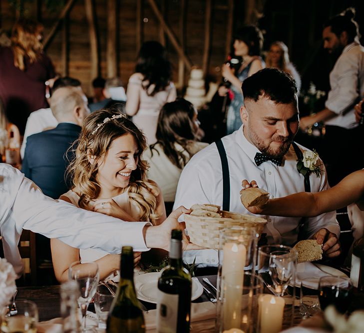 Wedding guests passing the bread basket 