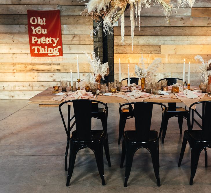 Place setting with metal chairs and wooden table 