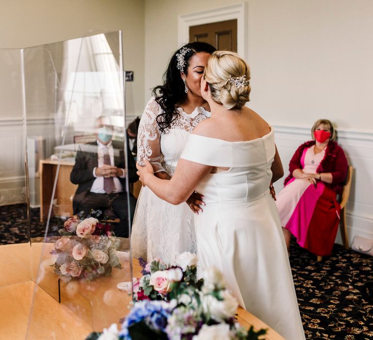 Brides kissing at wedding ceremony in Liverpool