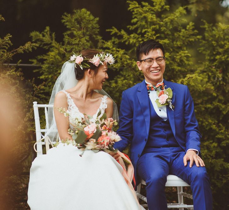 Bride and groom laughing during the outdoor wedding ceremony 