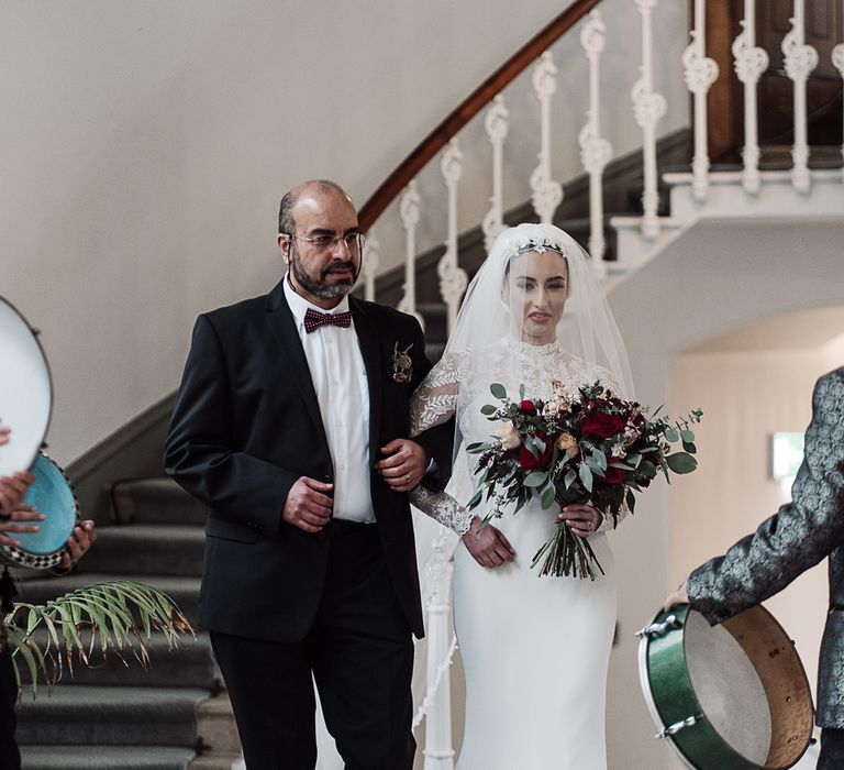 Father of the bride walking his daughter down the aisle 