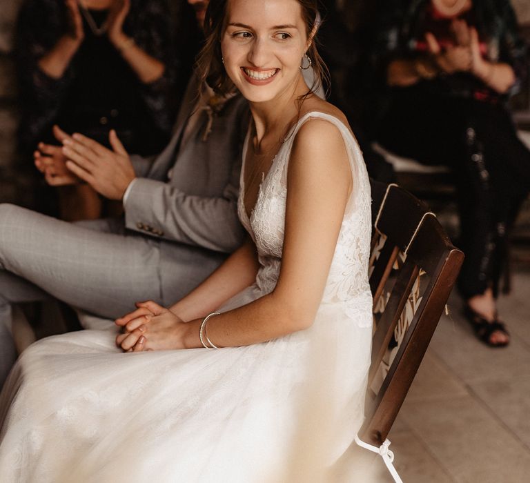 Bride getting married in lace and tulle dress smiling 