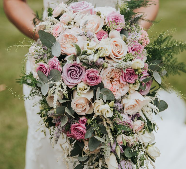 Pink, lilac and white bridal bouquet with roses and lisianthus