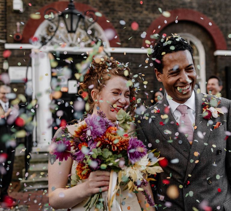 Colourful confetti exit at registry office micro wedding