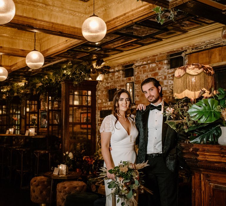 Bride and groom photography at Georgian townhouse with fringed lamp, velvet stools and cosy lighting