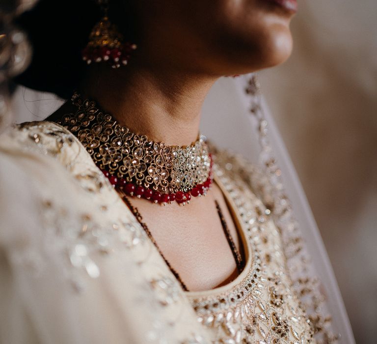 Bride wearing golden two piece featuring a gold necklace 