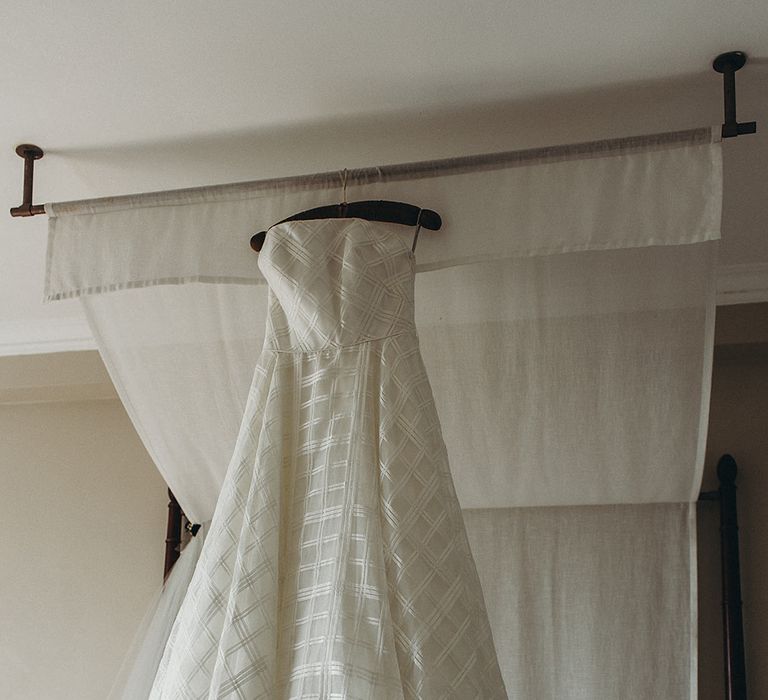 Strapless Wtoo wedding dress hanging up 