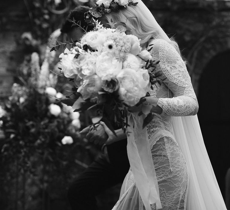 Bride in Grace Loves Lace Wedding Dress, single tier cathedral length veil and flower crown holding pink and white rose bouquet 