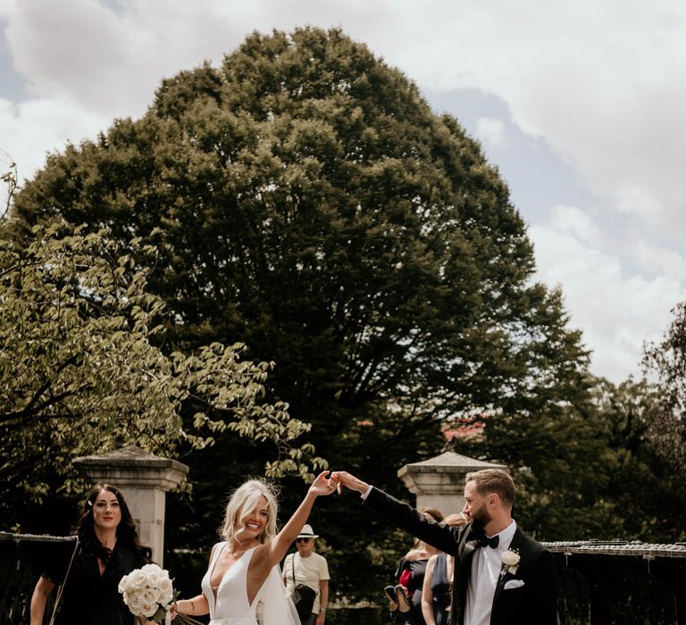 Groom twirls bride in Regents park