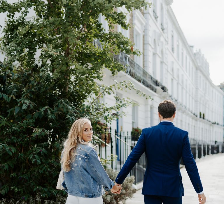 Bride wears personalised denim jacket and walks through London with her husband