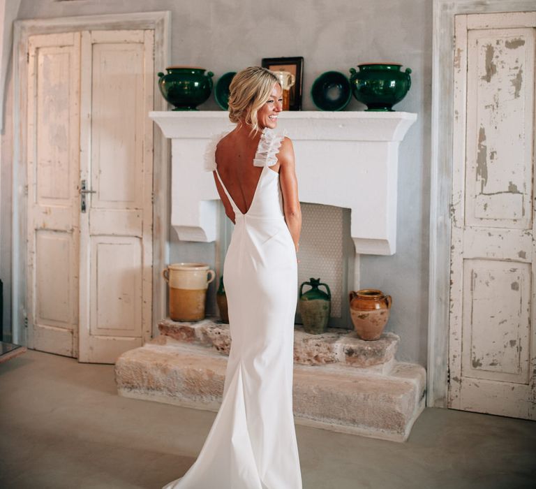 The bride getting ready at Masseria Potenti wearing a Halfpenny London gown