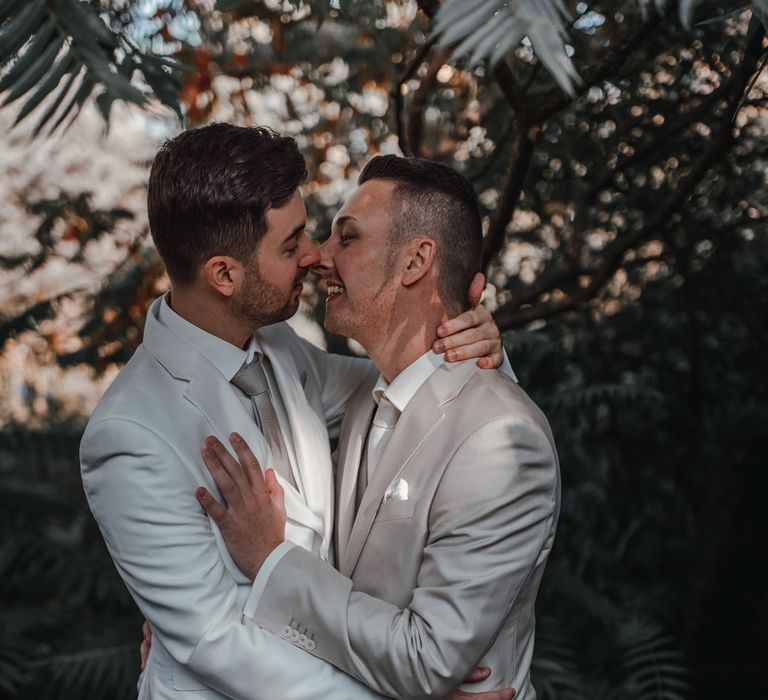 Grooms embrace at rooftop wedding in the Netherlands