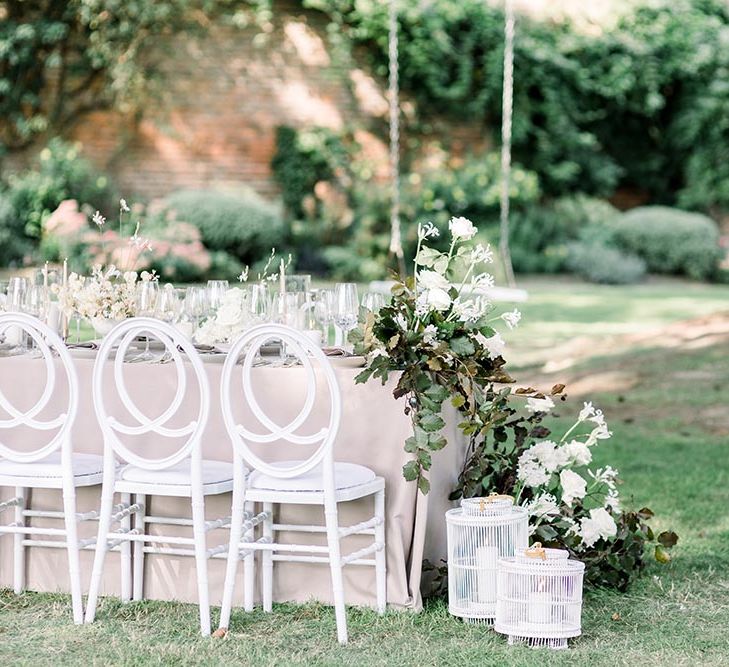 Wedding table floral arrangements with white flowers and foliage 