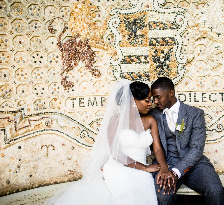 Black bride & groom look intensely at one another on their wedding day