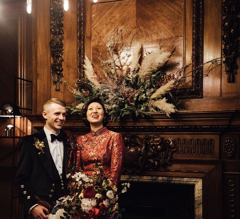 Pampas grass decor at town hall wedding with bride and groom in traditional outfits