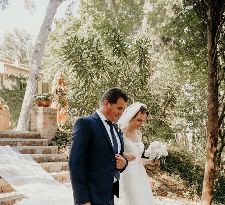 Bride walks down steps to the aisle with her father on her wedding day | Royal Studio