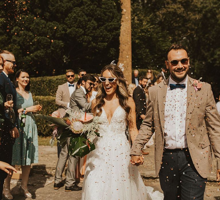 Bride & groom wear sunglasses outdoors on their wedding day