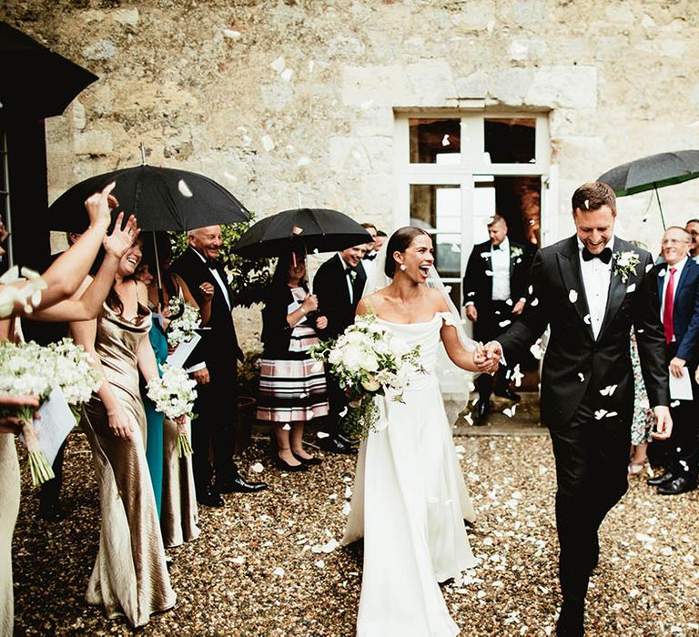 Bride & groom walk together hand in hand