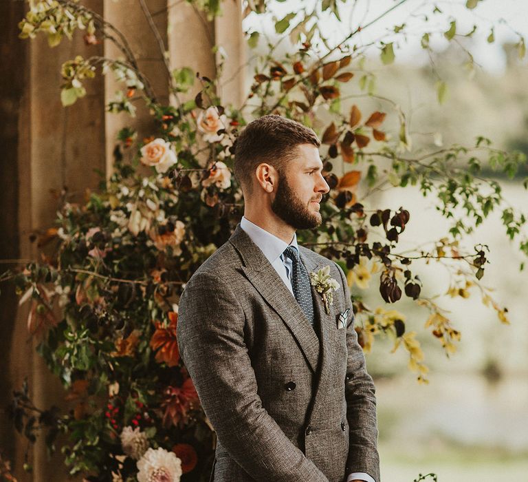 Groom awaits his brides arrival during wedding ceremony