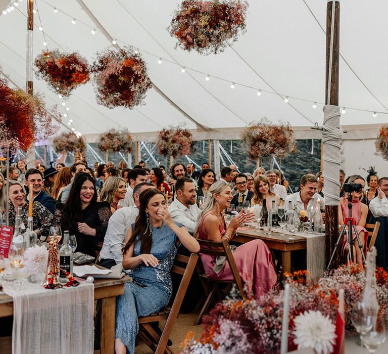 At home marquee wedding reception with pink gypsophila flower clouds 