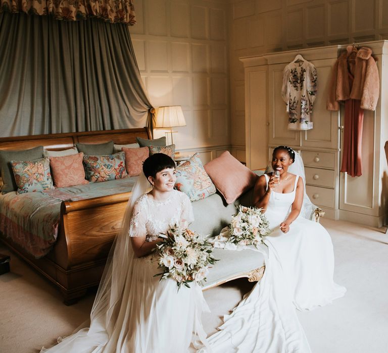 two brides sitting in the bridal suite at Elmore Court drinking Champagne 