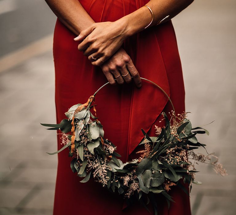 Burnt orange bridesmaid dress and foliage hoop bouquet 