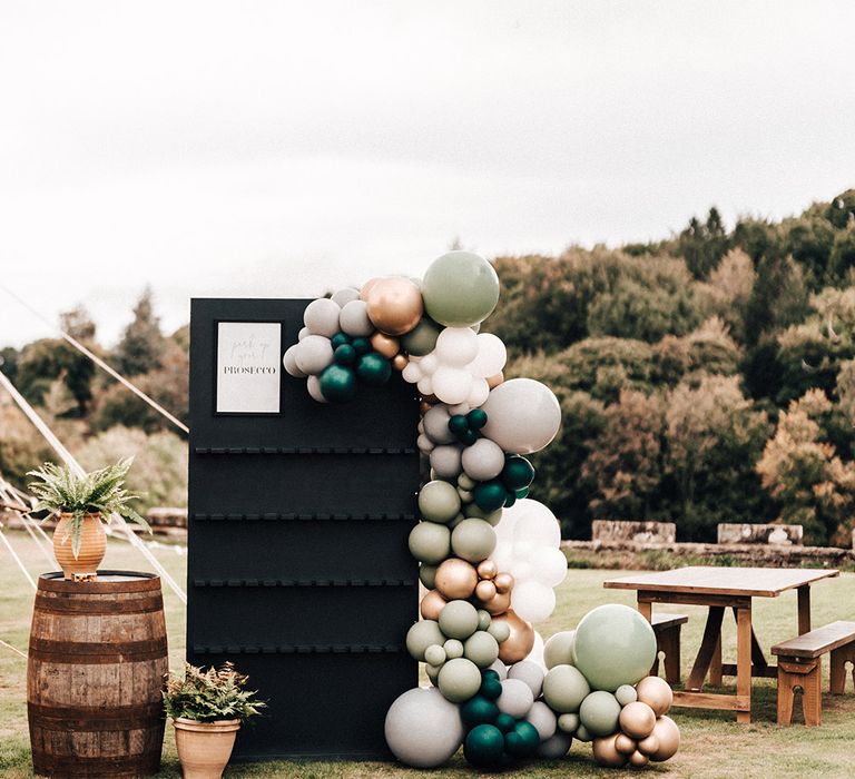 Prosecco station sign with green, grey, gold, white and blue balloons