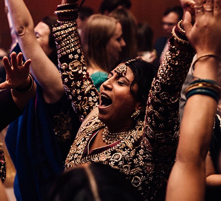 Guest in Indian saree dancing to music for weddings