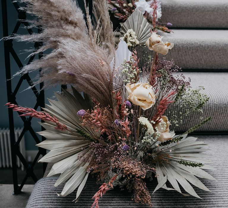 Staircase pastel flowers and dried grasses floral arrangement at Garthymyl Hall 