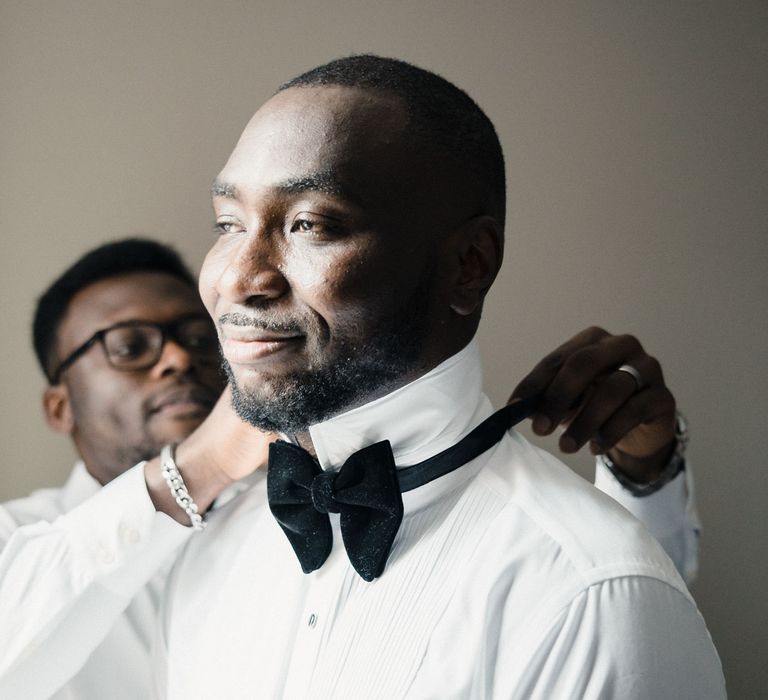 Groom wears velvet black tie for elegant and stylish wedding 