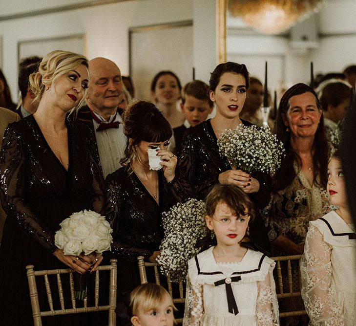 Bridesmaids wear black sequin bridesmaid dresses and become emotional during wedding ceremony at Belair House