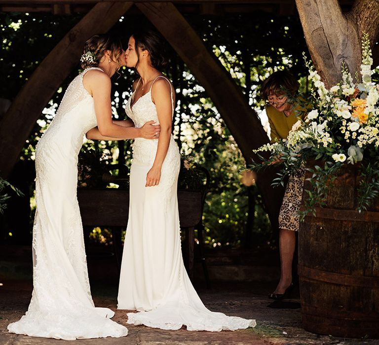 Brides share their first kiss as a married couple 