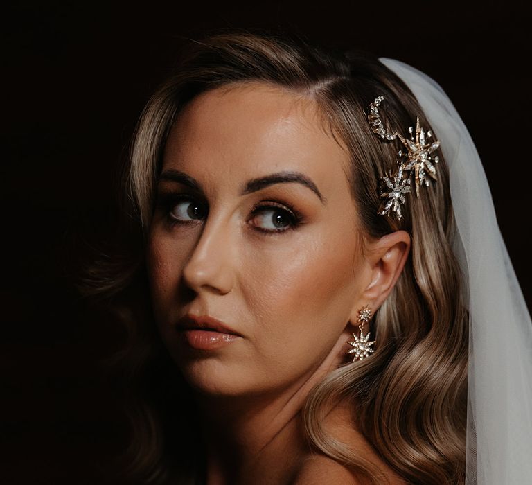 Bride with gold and diamante moon and stars wedding hair clips worn by the bride for a winter wedding 