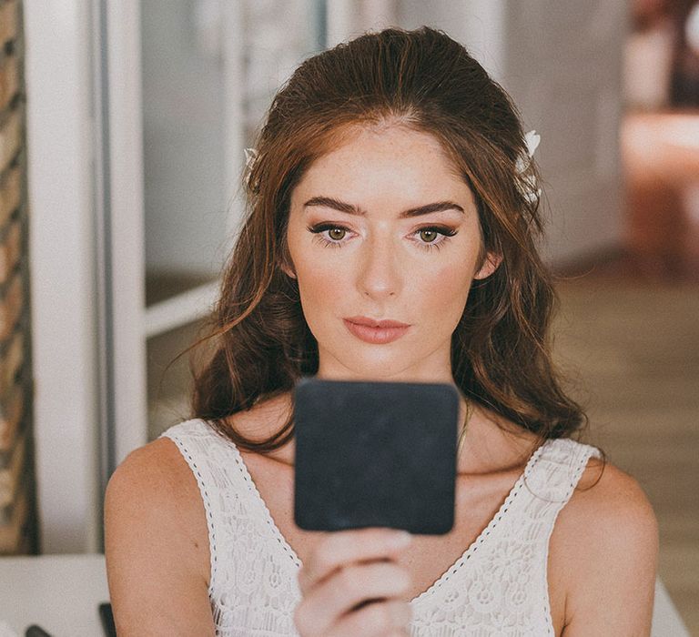 bride with long dark hair with natural bridal makeup up and winged eyeliner 