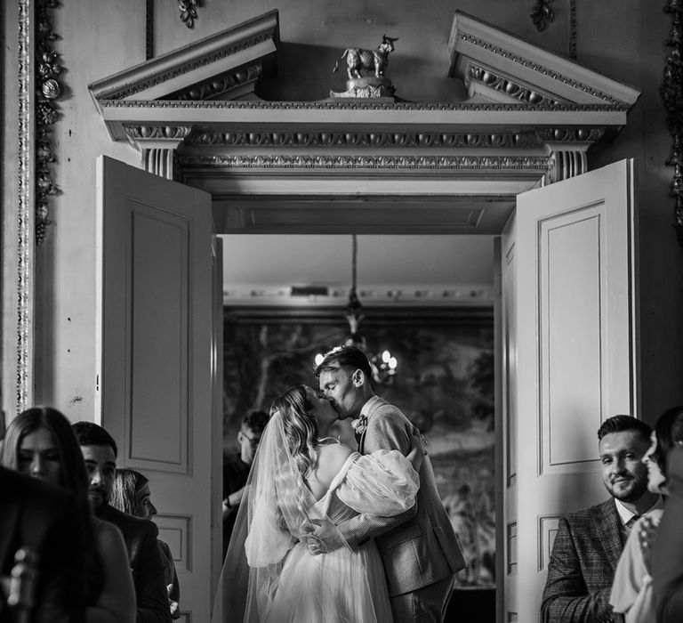 The bride and groom kiss at the end of the aisle after their traditional civil wedding ceremony 