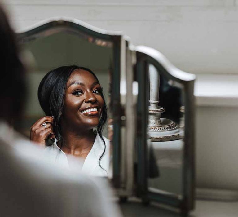 Bride doing bridal preparations at Lains Barn wedding venue Oxfordshire 