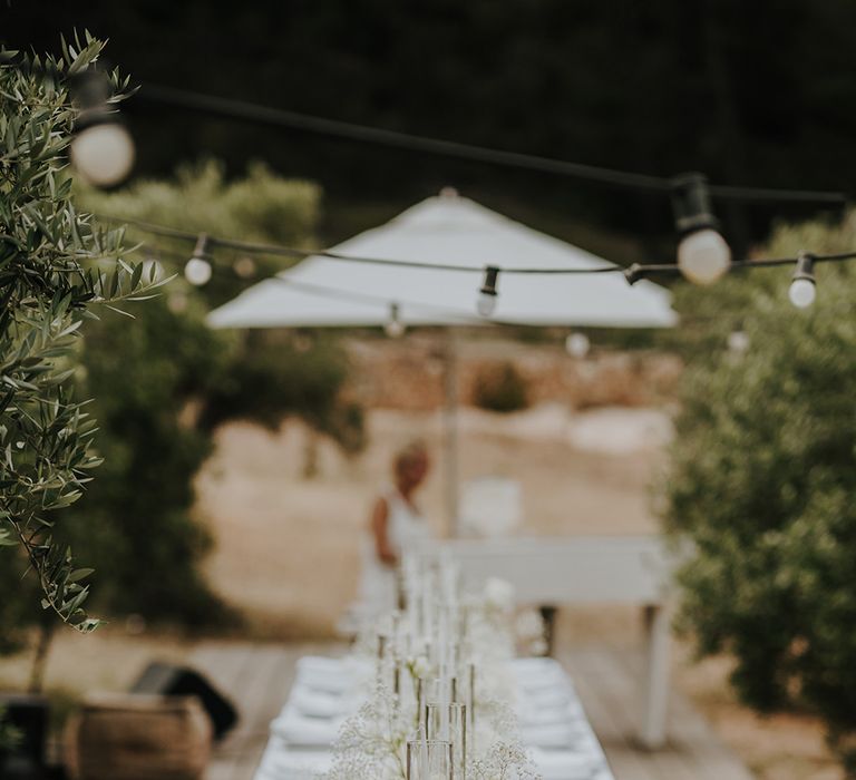 wedding reception table at pure house ibiza with white wedding flowers and candle centrepiece decor